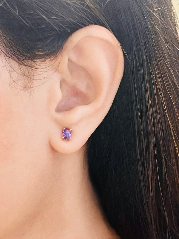 Model wearing amethyst stud earrings – elegant natural gemstone jewelry with purple hues
