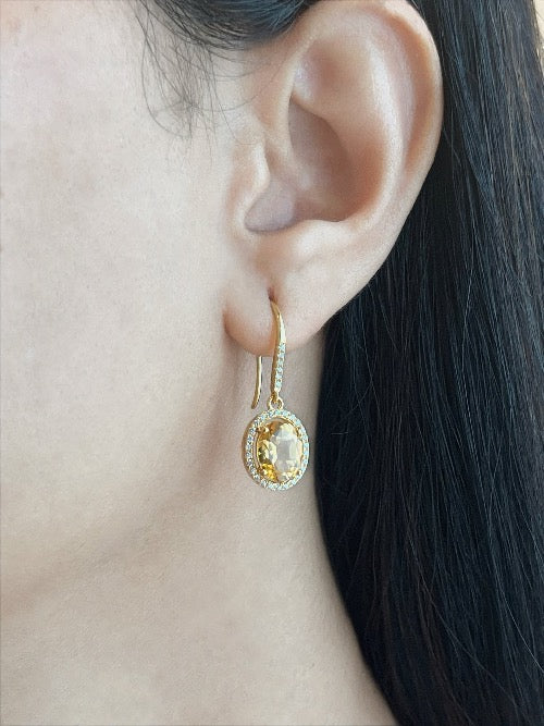Haspiera citrine yellow hook earrings with oval gemstone and sparkling accents on ear