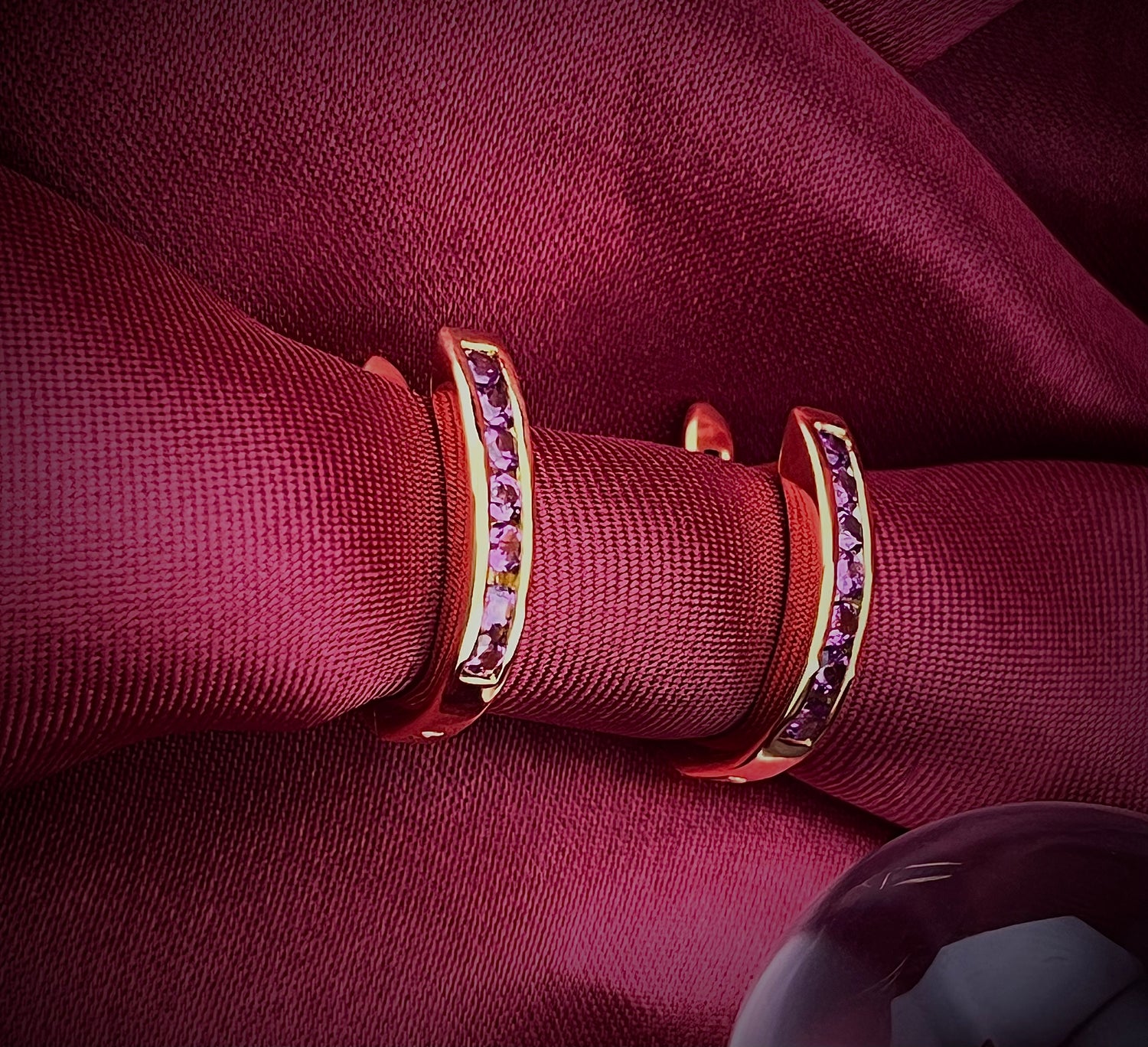 Haspiera gemstone gold hoop earrings featuring minimalist everyday earrings design on burgundy fabric