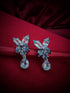 Haspiera elegant butterfly statement earrings with gemstone petals and teardrop dangles on red background