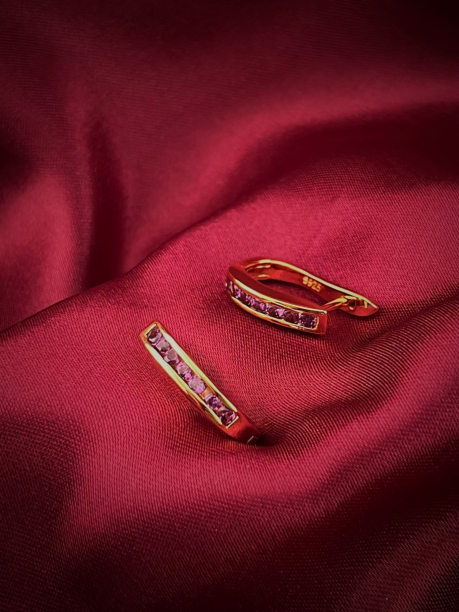 Haspiera gold gemstone earrings with pink stones minimalist everyday earrings on red fabric