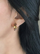Haspiera harvest hues earrings with multicolored gemstones worn on ear