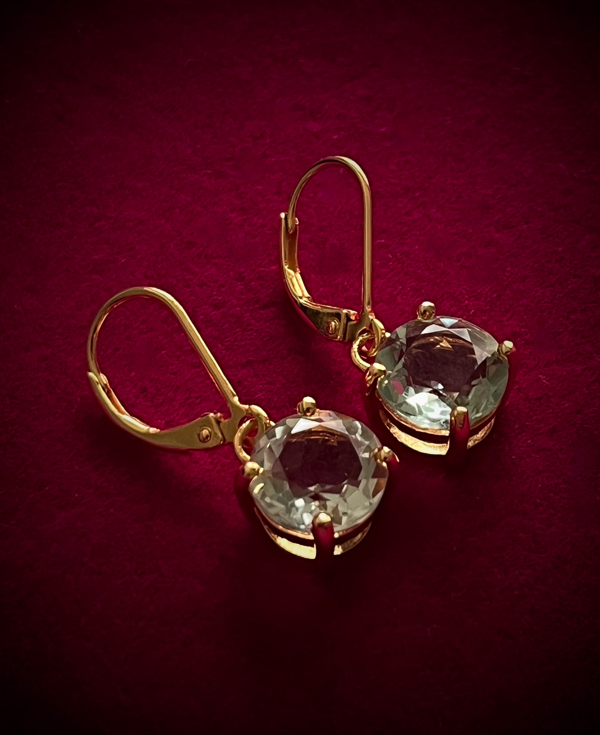Haspiera Kate's Love green amethyst drop earrings with gold setting on red background