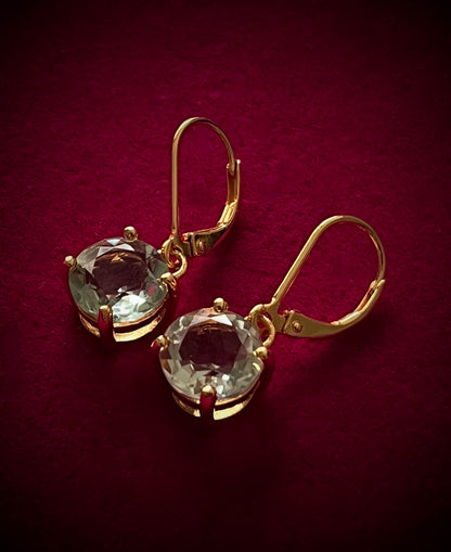 Kate's Love green amethyst drop earrings by Haspiera with gold setting on dark red background
