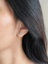 Haspiera lumidot stud earrings worn on a woman with dark hair showcasing gemstone sparkle