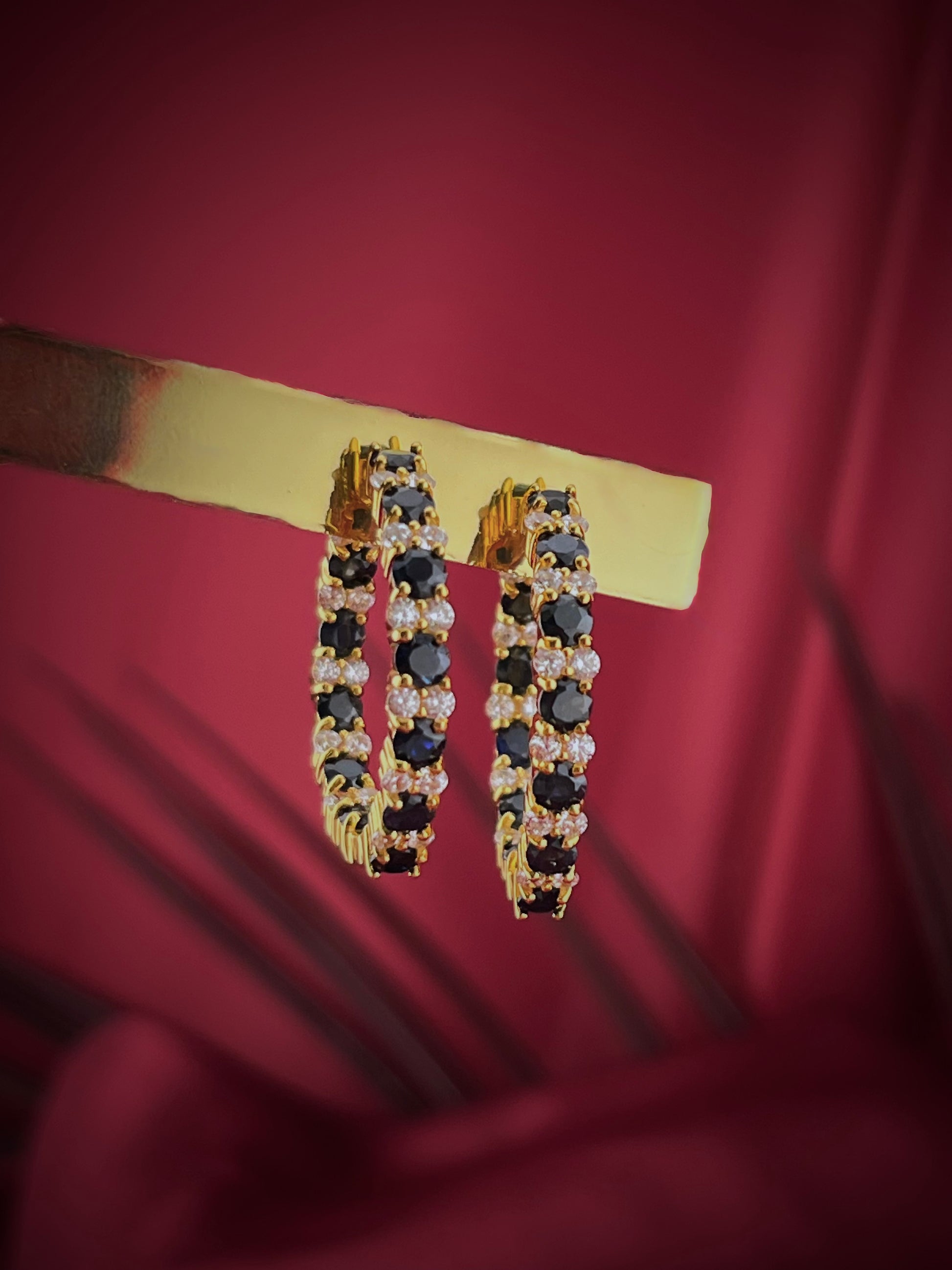 Haspiera elegant sapphire and cz hoops earrings with gold setting on red background