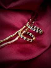 Haspiera elegant sapphire and cz hoops earrings on a burgundy fabric background