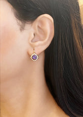 Haspiera violet amethyst halo gemstone earrings worn on ear with gold setting