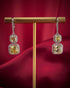 Haspiera yellow dangle earrings in silver with two square yellow gemstones on gold stand